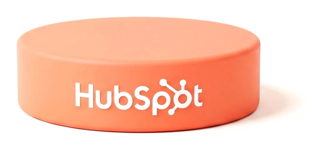 HubSpot logo on a coral hockey puck