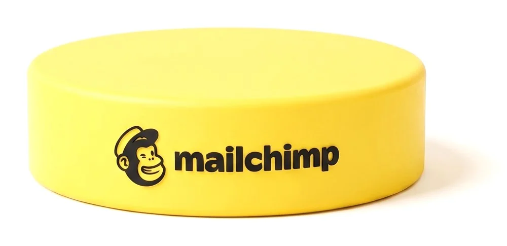 Mailchimp logo on a yellow hockey puck