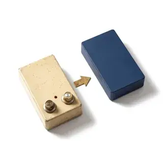 A worn beige device beside a new navy device, with a brass arrow between them.